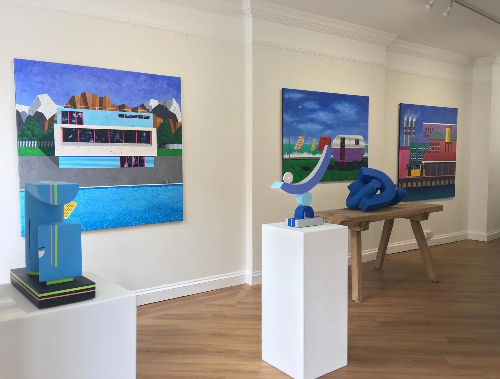 A gallery with three of the architectural paintings on its walls, and sculptures on plinths